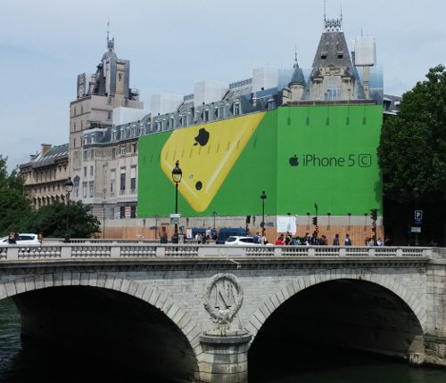 Nortre Dame bridge with building behind it with a huge iPhone 5c advertisement all over its facade.